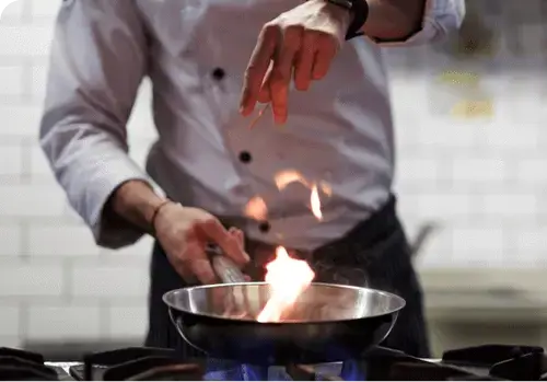 Picture of chef cooking on hob, checked by a registered gas safe engineer.