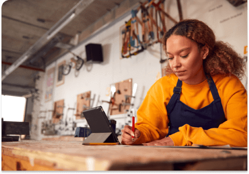 Lady in a workshop doing business accounts