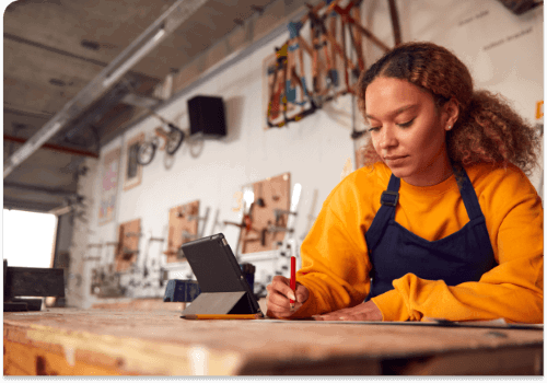 business electricity comparison uk Lady in a workshop doing business accounts
